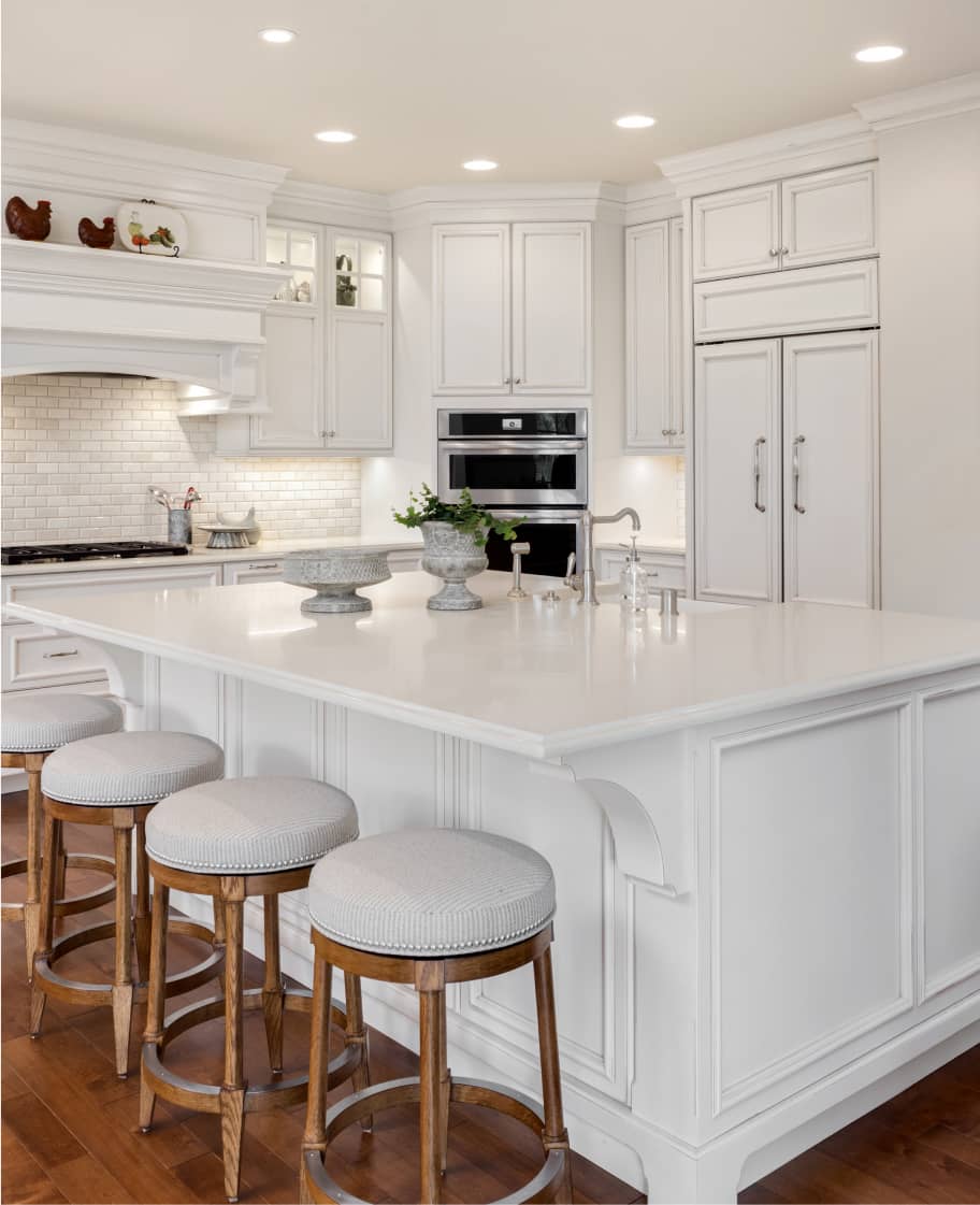 white resurfaced countertops with white cabinets in kitchen